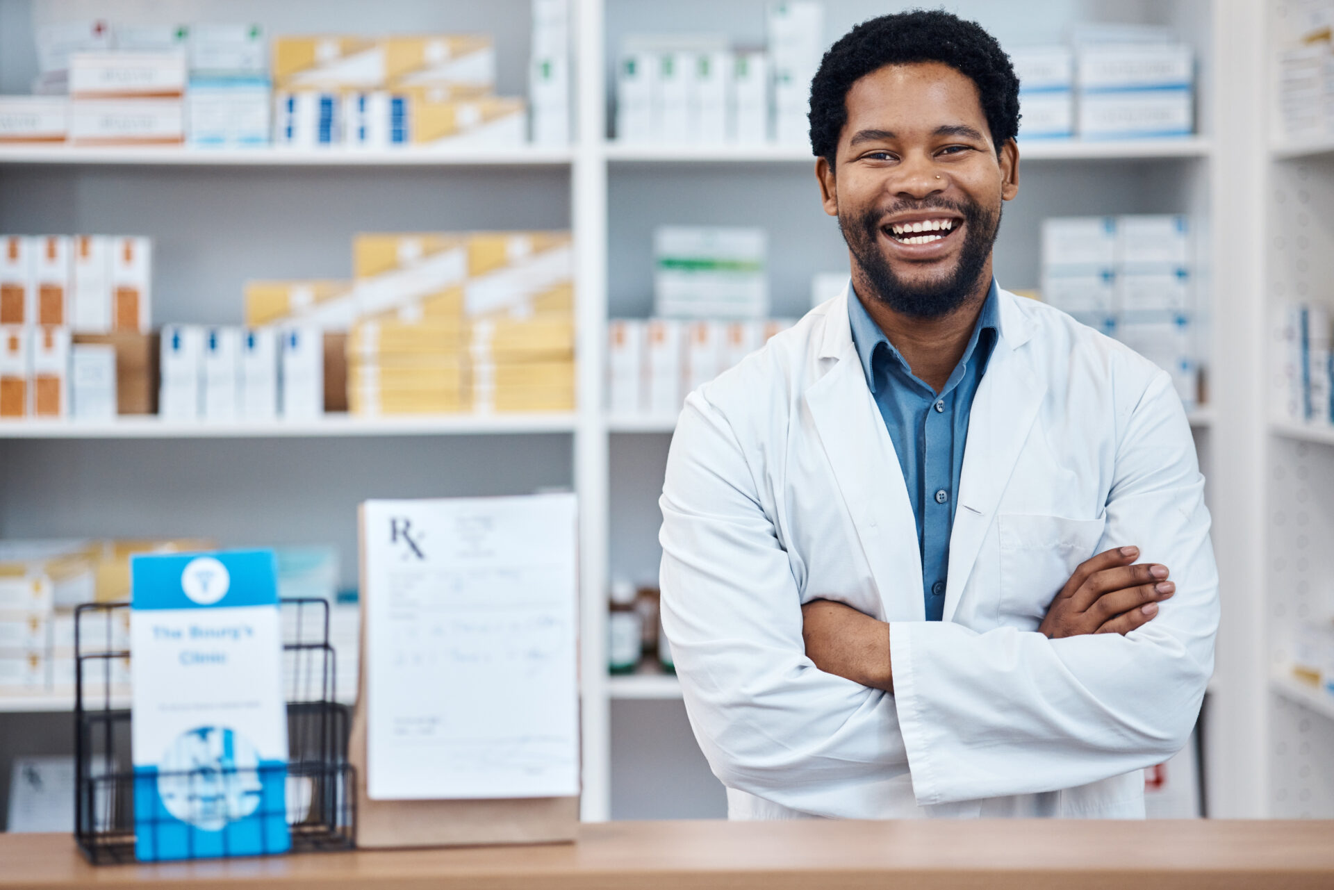 Man in lab coat in a pharmacy