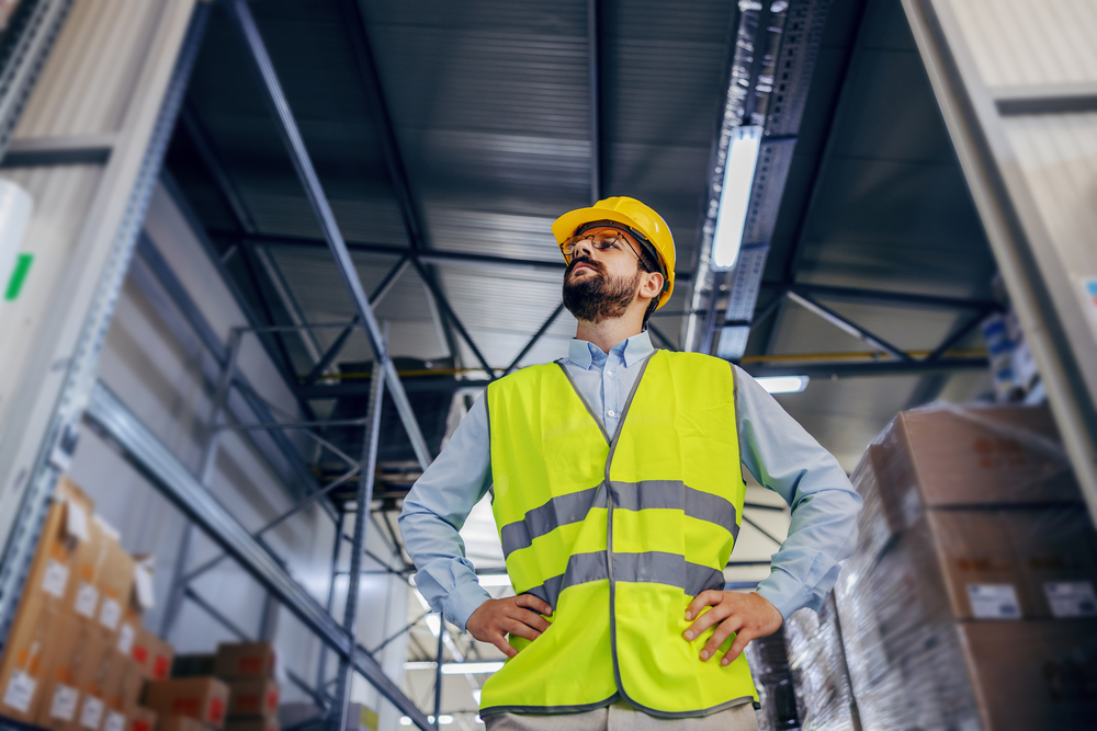 Warehouse employee with hands on hips