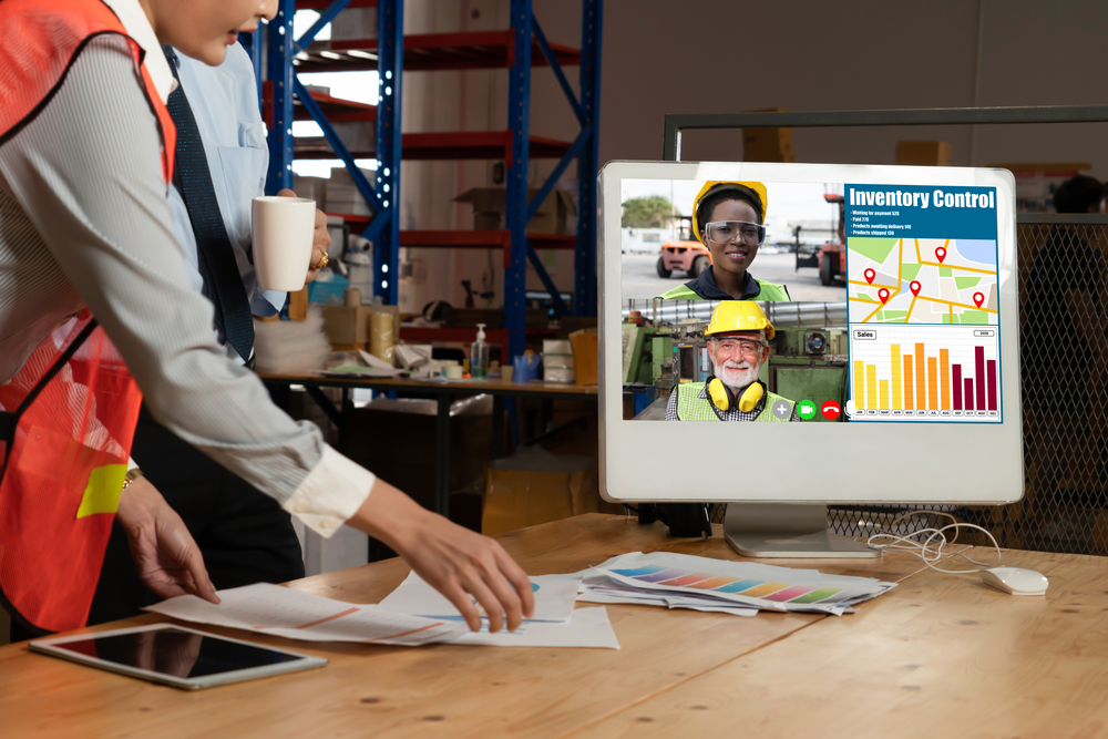 2 people in a warehouse talking to 2 people on a video call