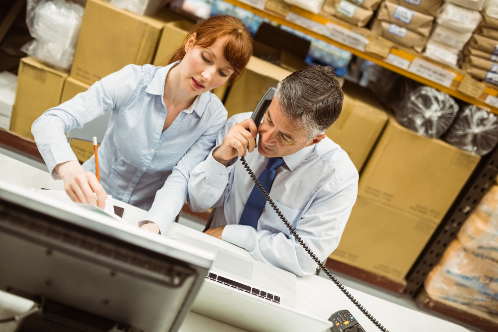 Managers on phone in warehouse