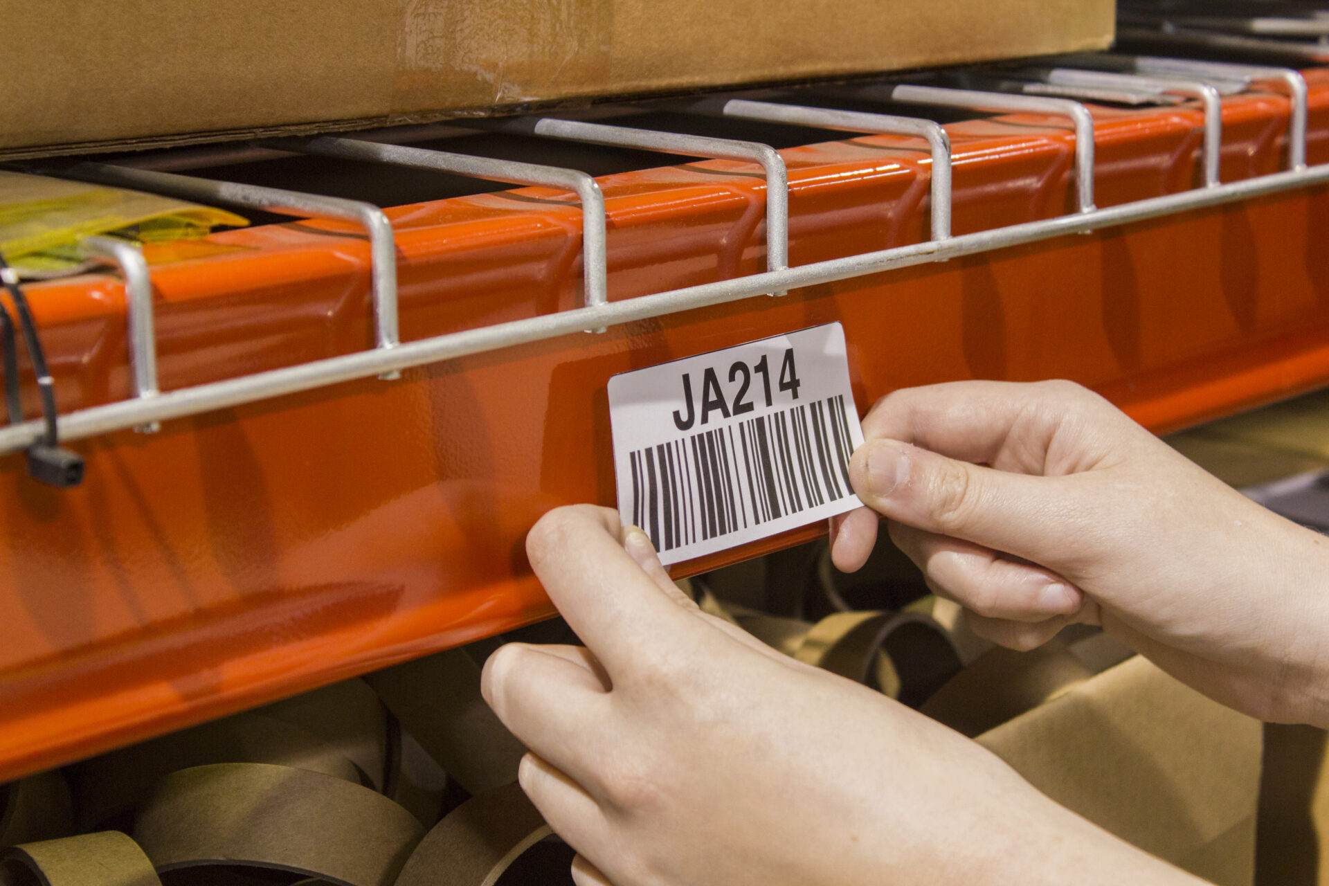 Warehouse worker applying label to rack